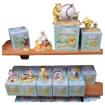 22 boxed Royal Doulton Winnie The Pooh Collection figures, and money box, Pooh's Blue Balloon, H10.