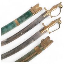 A pair of Indian brass-mounted short swords, engraved blades and velvet-covered scabbards, blade