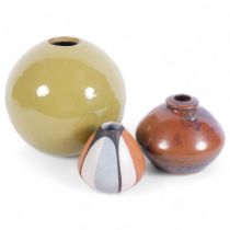 A green glazed terracotta globular Studio pottery pot, H18cm, a Raku glazed pot and another,