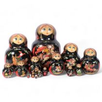 A large graduated set of painted Russian dolls, tallest 22cm, signed and dated 1998