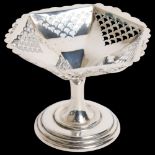 A George V silver bon bon dish of small size, with a canted and pierced body on turned base, H7cm,