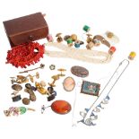 A group of various costume jewellery, including a coral bracelet, a relief carved cameo, various