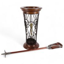 A stained beech circular stick stand with wrought-iron decoration, and a Vintage shooting stick