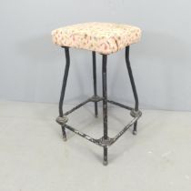 A vintage industrial stool, with tubular metal frame. Height 64cm.