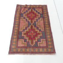 A red-ground Baluchi rug. 128x86cm.