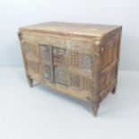 An early 19th century carved Indian hardwood Damchiya dowry chest with later top and shelf, with