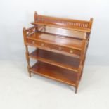A continental mahogany three-tier buffet, with raised mirror back and two drawers, and carved and