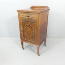 A 1930s mahogany bedside cabinet, with raised back and inlaid decoration. 41x82x41cm.