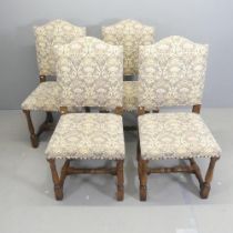 A set of four early 20th century oak and upholstered dining chairs.