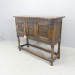 An early 20th century Jacobean style oak cabinet, with carved decoration, turned legs and all around