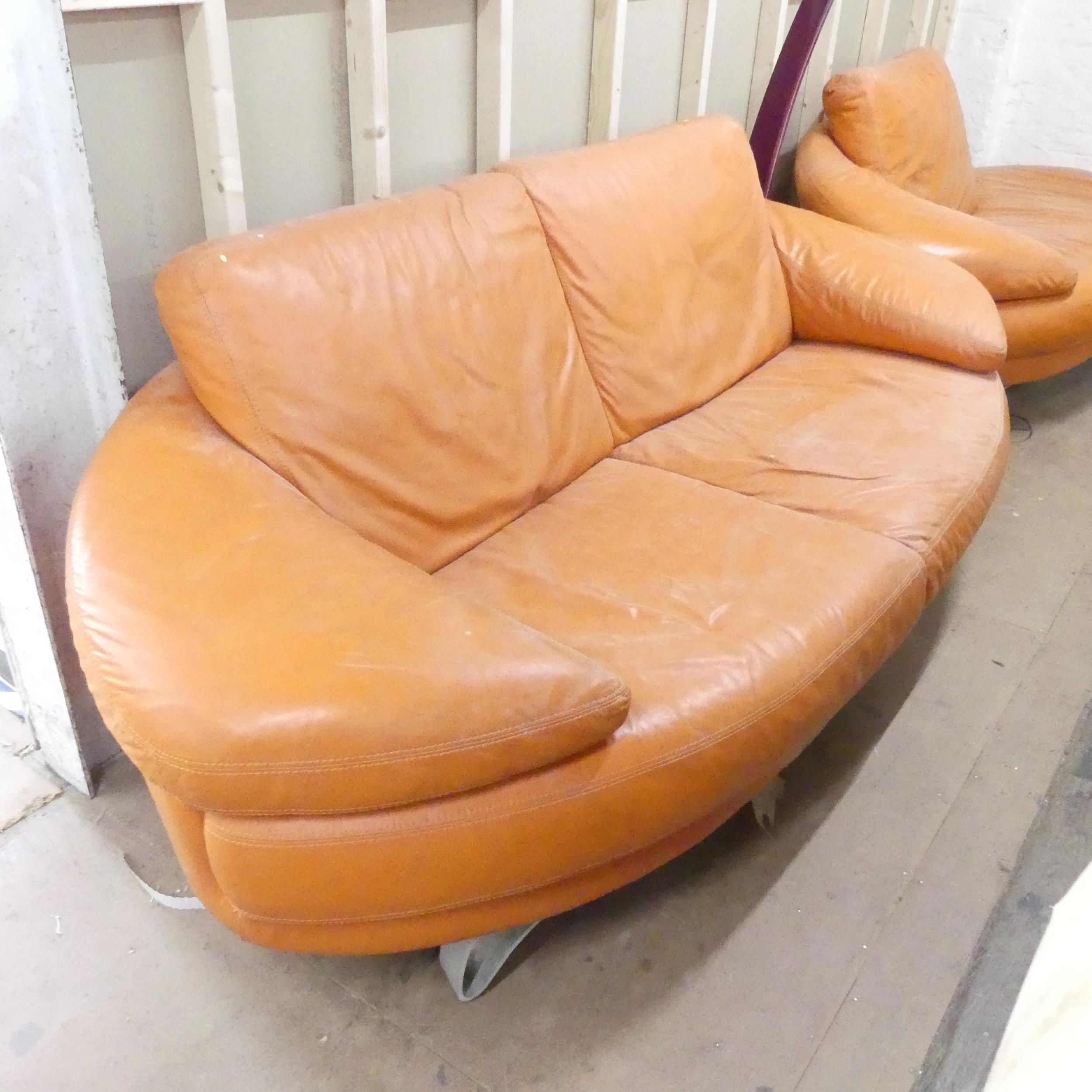 A contemporary orange leather upholstered lounge suite comprising a two-seater sofa, chaise longue