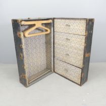 A vintage metal-bound travelling wardrobe, with label for Watajoy. Dimensons (closed) 37x93x56cm.