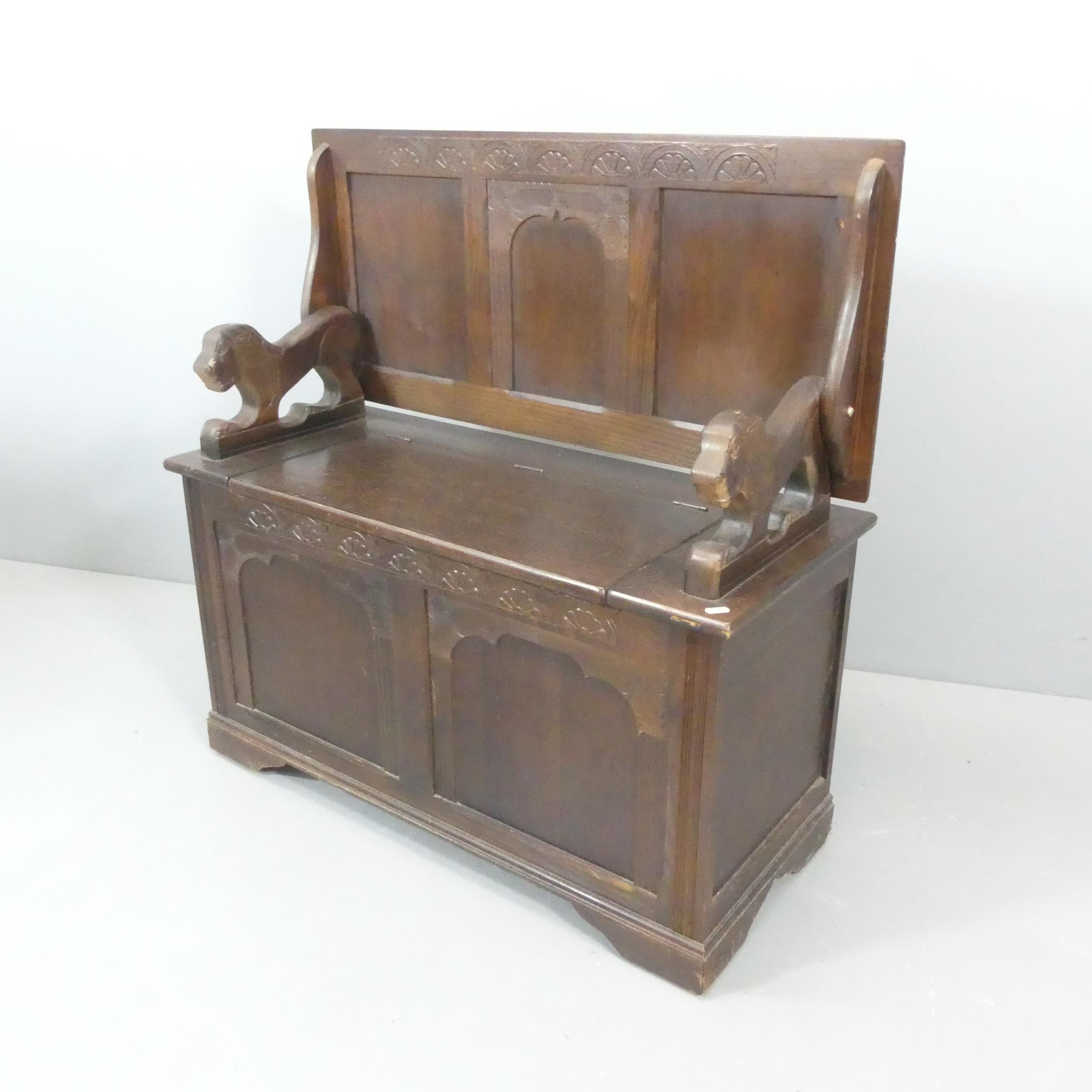 A panelled oak monks' bench. Dimensions (as bench) 96x98x42cm.