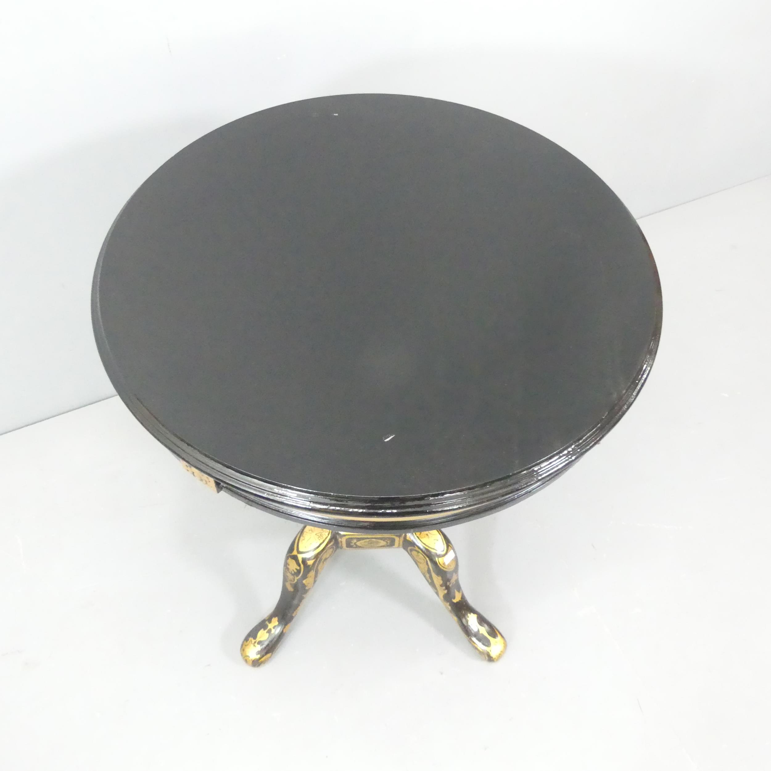 A Continental style ebonised and gilt-painted circular occasional table, with carved and painted - Image 2 of 3