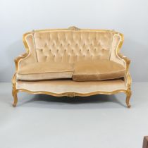 A continental walnut and button-back upholstered two-seater settee, with carved decoration and