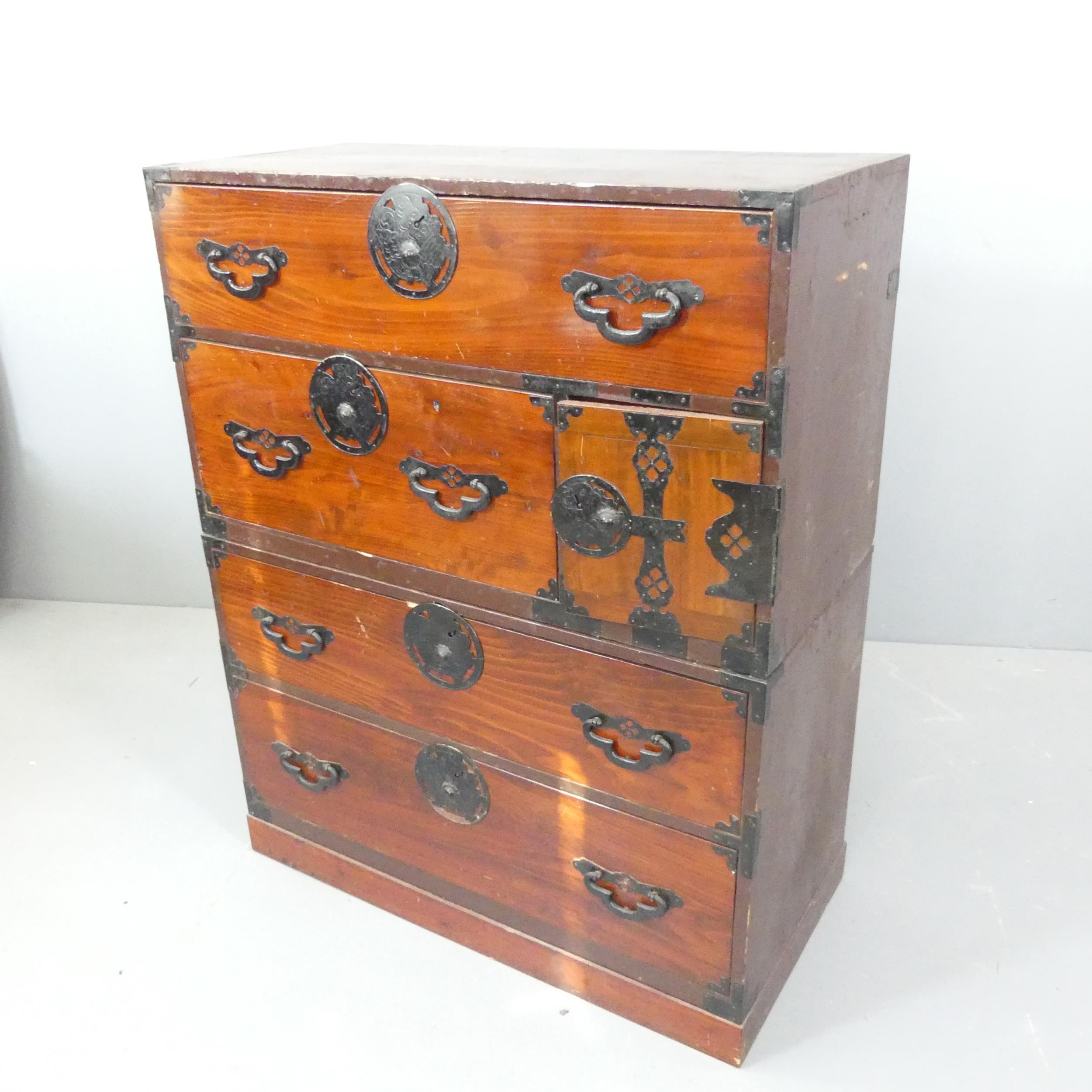 A Japanese kiri-wood two-section Tansu chest of four long drawers, with cupboard door revealing