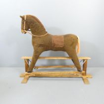 A vintage rocking horse on oak base. Overall 130x108x45cm.