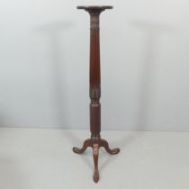 A 19th century style mahogany torchere, with carved decoration and tripod base. Height 132cm.