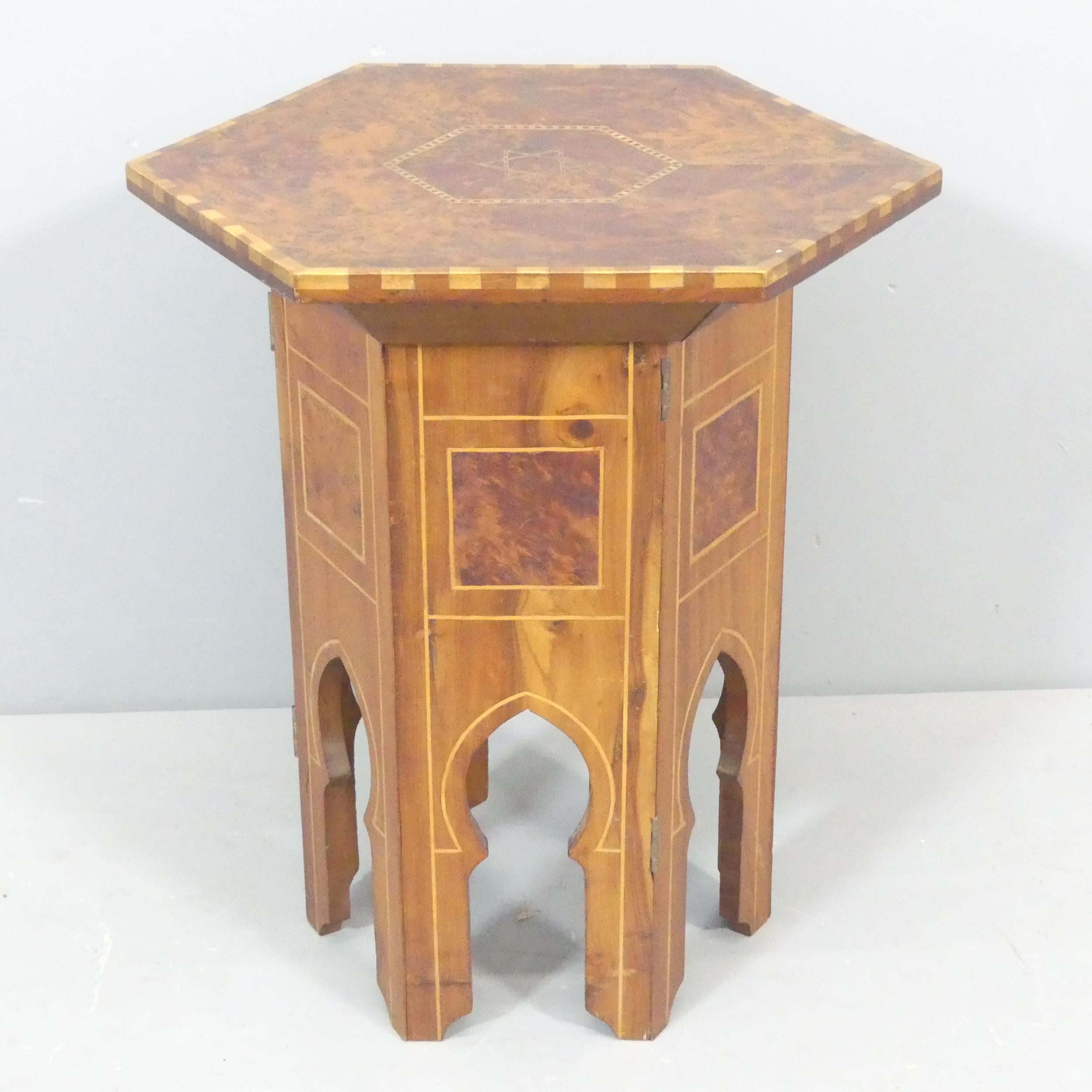 An antique Islamic Amboyna and satinwood strung hexagonal occasional table, with inlaid