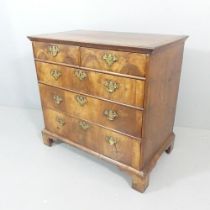 A Georgian crossbanded mahogany chest of two short and three long drawers, with flame veneered