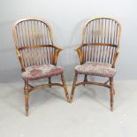 A pair of bow-arm Windsor kitchen elbow chairs, with upholstered seats and crinoline stretchers.