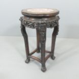 A Chinese marble topped jardiniere stand, with carved decoration, 34x63m
