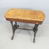 A Victorian walnut fold-over card table, with a selection of games. 90x73x44cm.