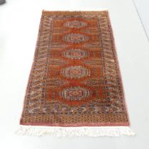 A red-ground Turkomen rug. 162x95cm.
