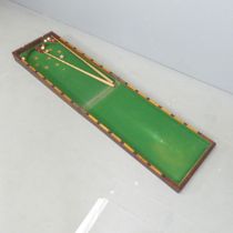 A Victorian Table Top Bagatelle Game with satin wood cup pockets, baize covered board, housed in a