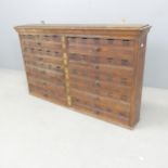 An early 20th century stained pine bank of ten printer's drawers. 105x63x16cm.