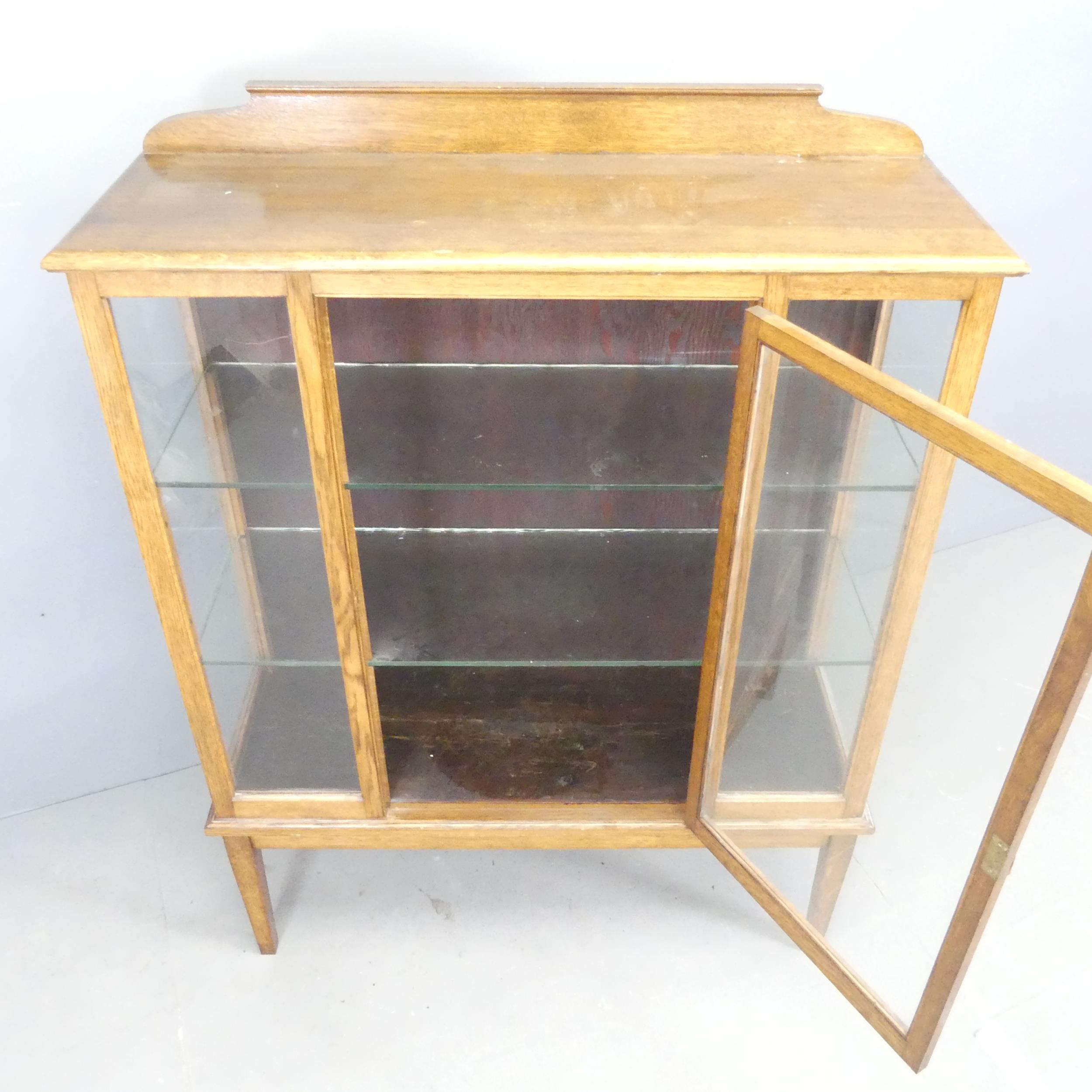 A 1930s oak display cabinet. 103x136x36cm. - Image 2 of 2