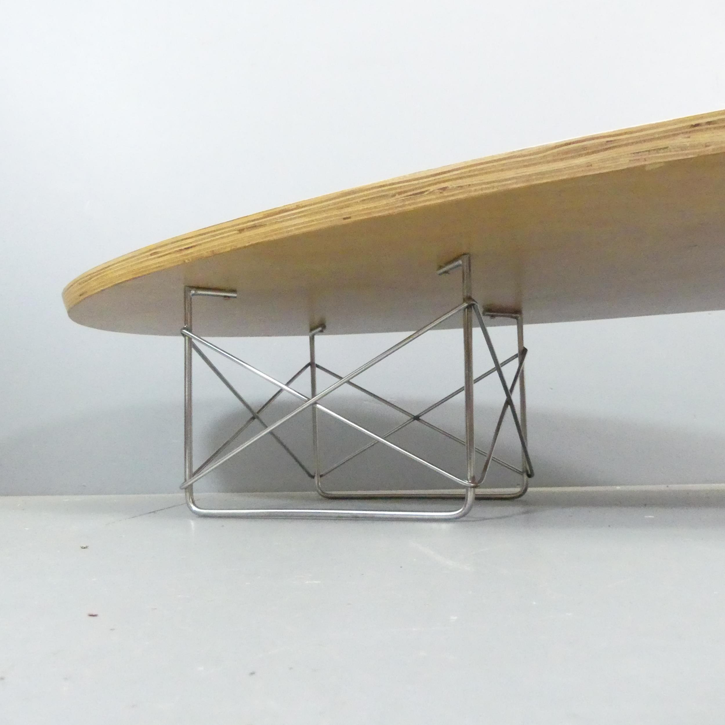 An elliptical surfboard coffee table in the manner of Charles and Ray Eames. 179x26x58cm. - Image 3 of 3