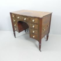 A Georgian style mahogany and ebony strung kneehole writing desk, with fluted legs, four drawers (