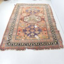 A red-ground Kilim carpet. 240x164cm. Faded and torn. Would benefit from a good clean and some