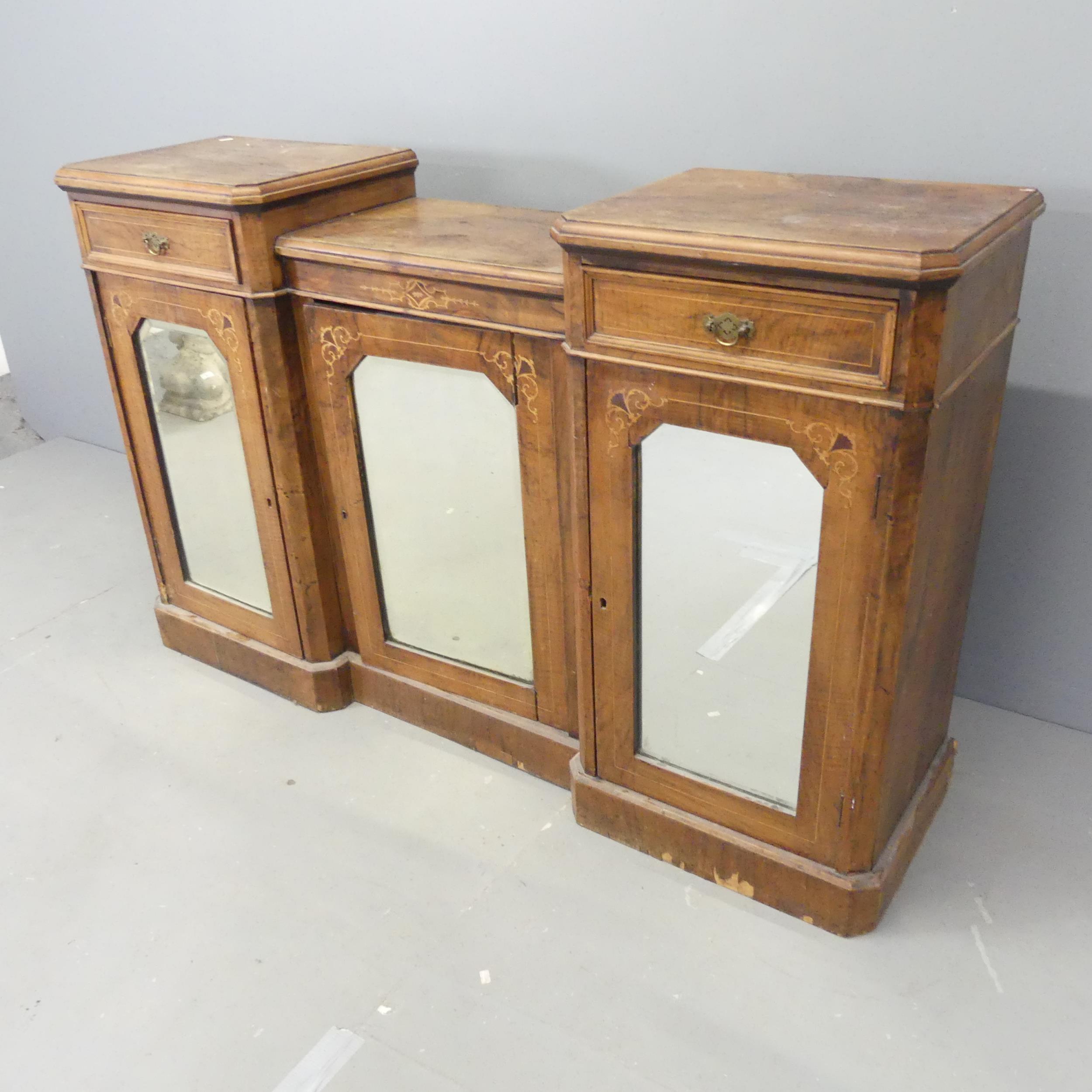 A 19th century walnut and satinwood strung drop-centre sidebard, with three mirror panelled doors,