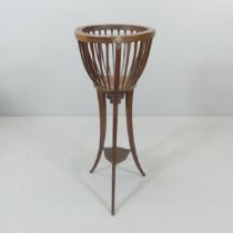 An Edwardian mahogany two-tier jardiniere stand. 35x90cm. Some minor splits and veneer loss. No