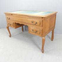 A French oak kneehole writing desk, with inset felt skiver, three drawers and cabriole legs. Overall