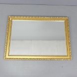 A modern rectangular gilt-framed bevel edged wall mirror. 105x75cm.