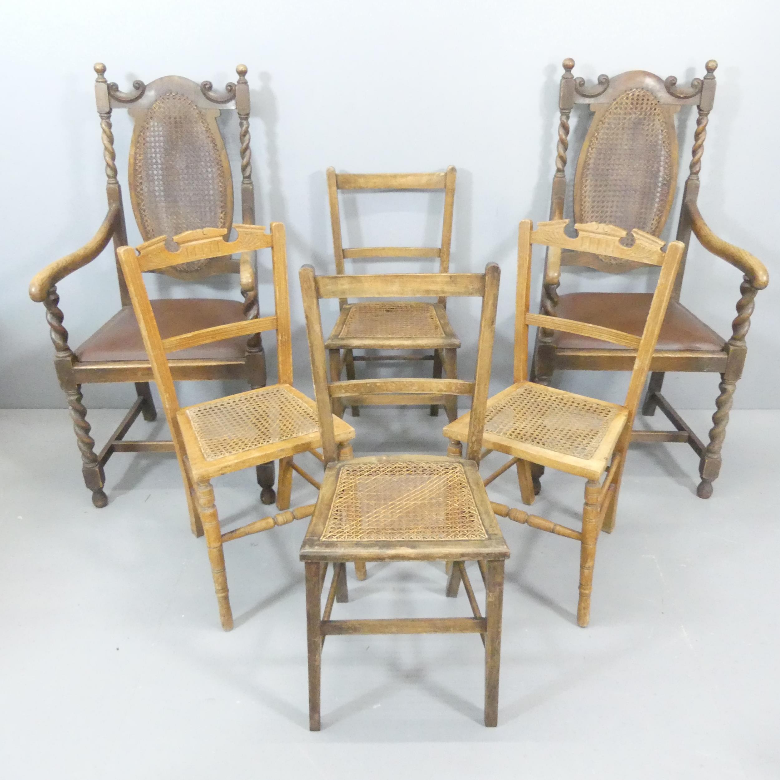 A pair of Jacobean style cane backed open arm chairs, and two pairs of cane seated dining chairs. (