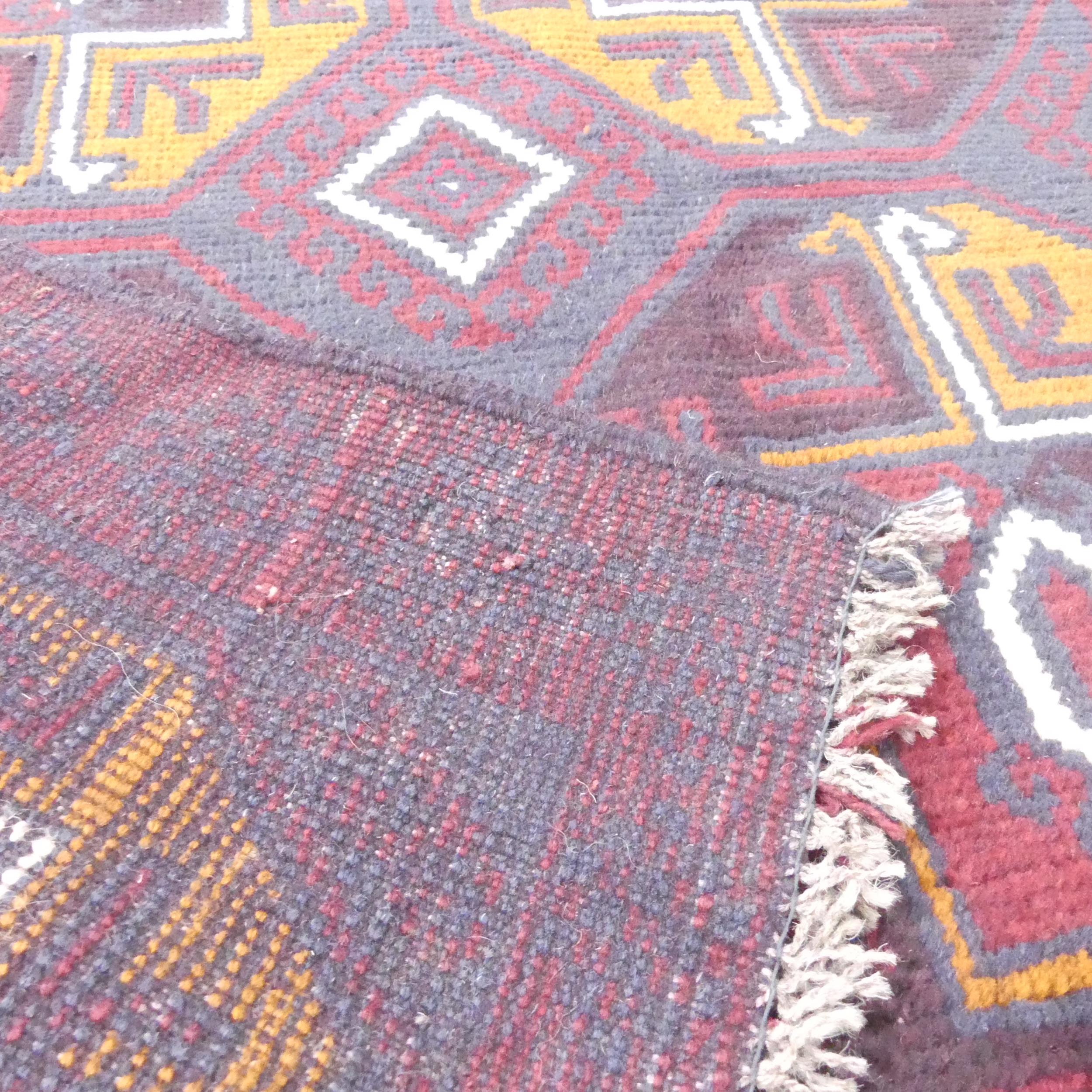 A red-ground Baluchi rug. 146x89cm. - Image 2 of 2