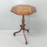 A 19th century mahogany octagonal games top table, on tripod base, width 44.5cm, height 73cm.