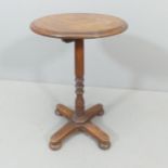 An antique mahogany tilt-top wine table. 40x58cm.