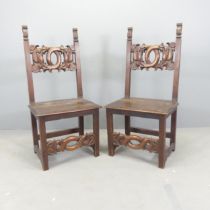 A pair of 19th century Italian Renaissance Revival oak hall chairs with auricular carved back and