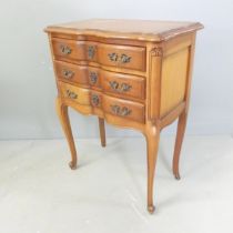 A French walnut bedside chest of three drawers, raised on cabriole legs. 52x70x30cm.