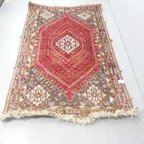 A red-ground Persian rug. 250x156cm.
