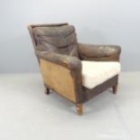An early 20th century leather upholstered club armchair. Overall 80x90x80cm, seat 50x40x55cm.