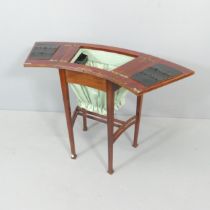 An Edwardian Arts & Crafts work table in the manner of Liberty, the top opening to reveal a fitted