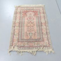A salmon-ground Persian prayer rug. 130x89cm.