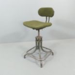 A mid-century industrial machinists' swivel stool.