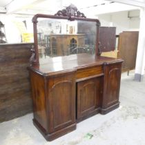 A Victorian mahogany break-front sideboard, with raised mirror back and arch panelled doors.